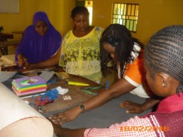 Olga teaching craft making to deaf teachers and students